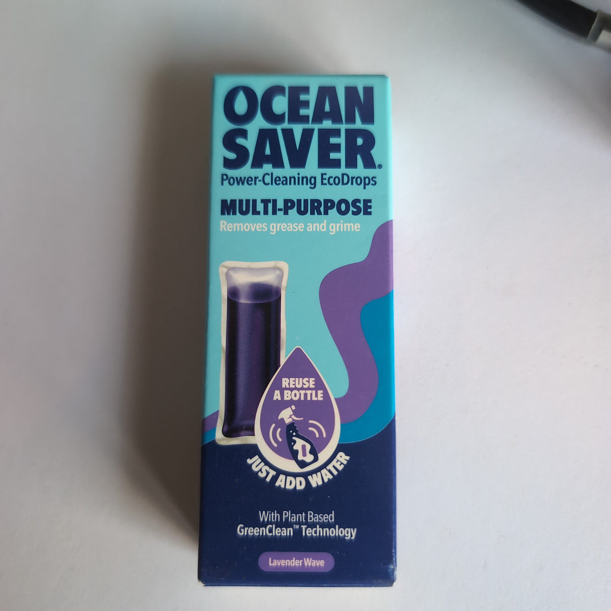 Ocean Saver Multi-Purpose Power-Cleaning EcoDrops in lavender scent, shown in its original blue and purple cardboard packaging box on a light gray surface.